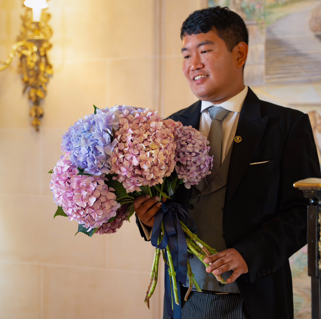 The Ritz Butler carrying flowers at The Ritz London