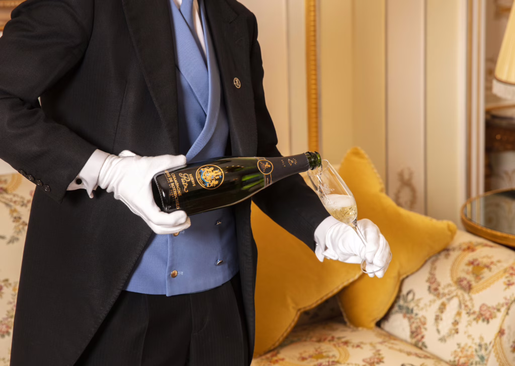 The Ritz Butler pouring Champagne at The Ritz London