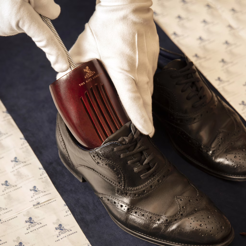 The Ritz Butler putting shoe horn in shoe at The Ritz London