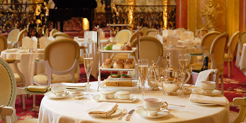 Afternoon tea table setting in The Ritz London parlour featuring glasses of champagne