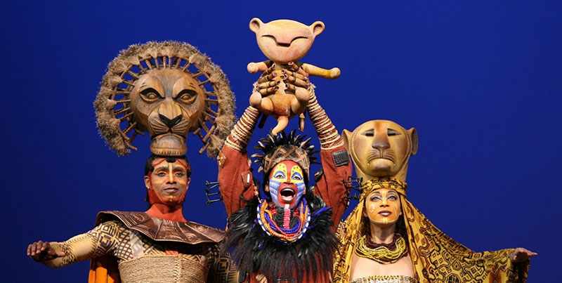 The Lion King theatre performers in costume on stage
