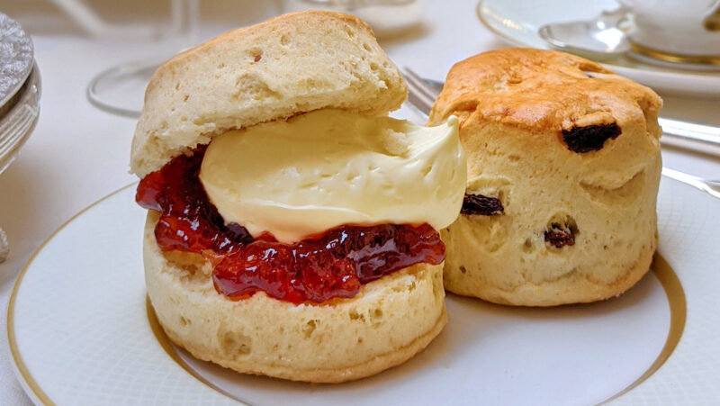 A scone with cream and jam