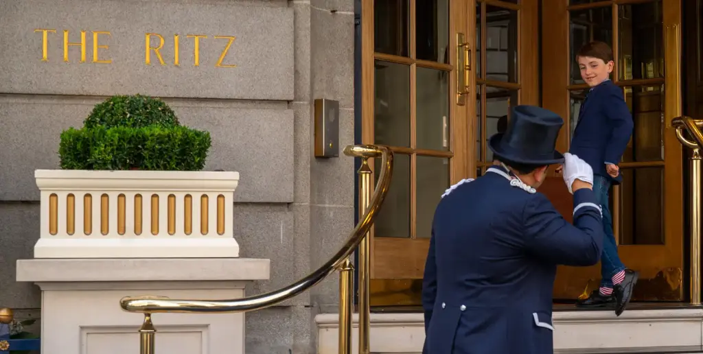 The Ritz London doorman greeting a child entering the hotel