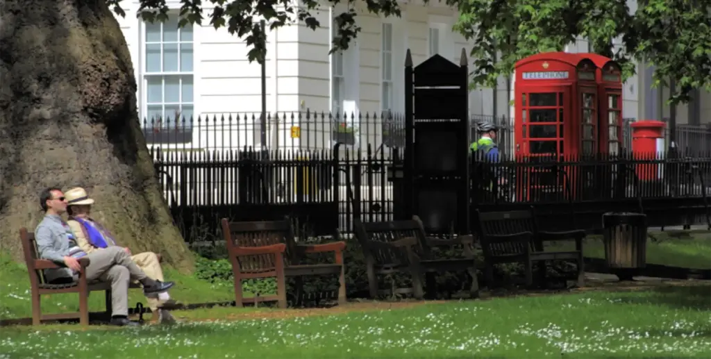 Two people sitting on a bench in Berkeley Square